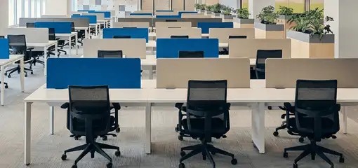 Modern open-plan office space featuring clean workstations, ergonomic chairs, and sanitized carpets provided by professional office cleaning services in Salt Lake City, UT.