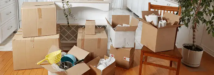 Packed moving boxes and household items in a kitchen before move-out or move-in cleaning, Salt Lake City, UT.